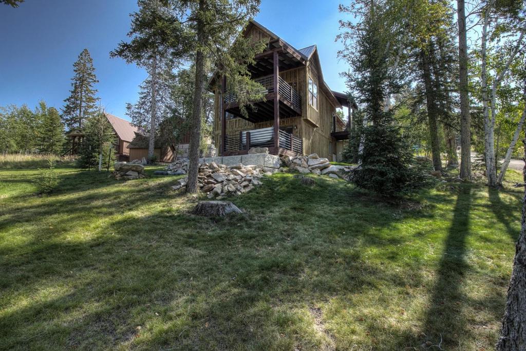 a home in the woods with a large yard at Lost Buffalo Lodge in Lead