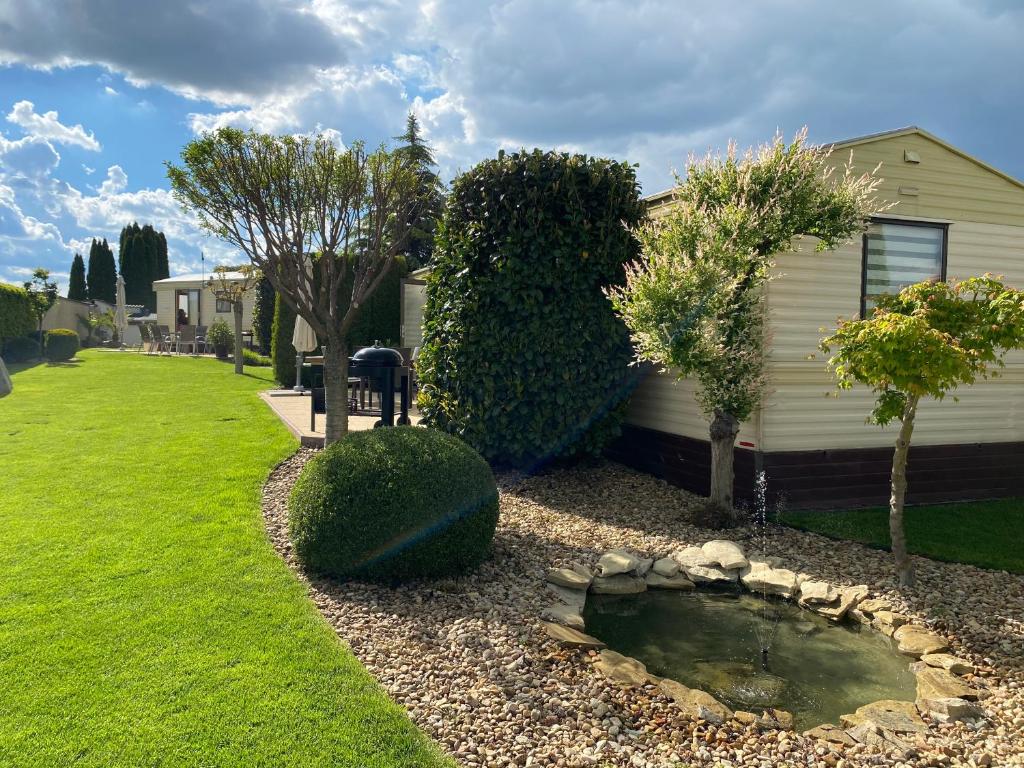 a house with a pond in the front yard at Penzion Verde in Mikulov