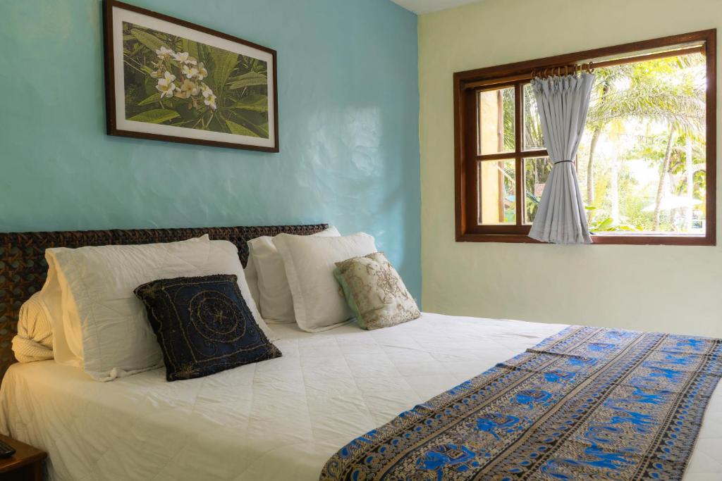 Uma cama ou camas num quarto em Atmosphera Pousada