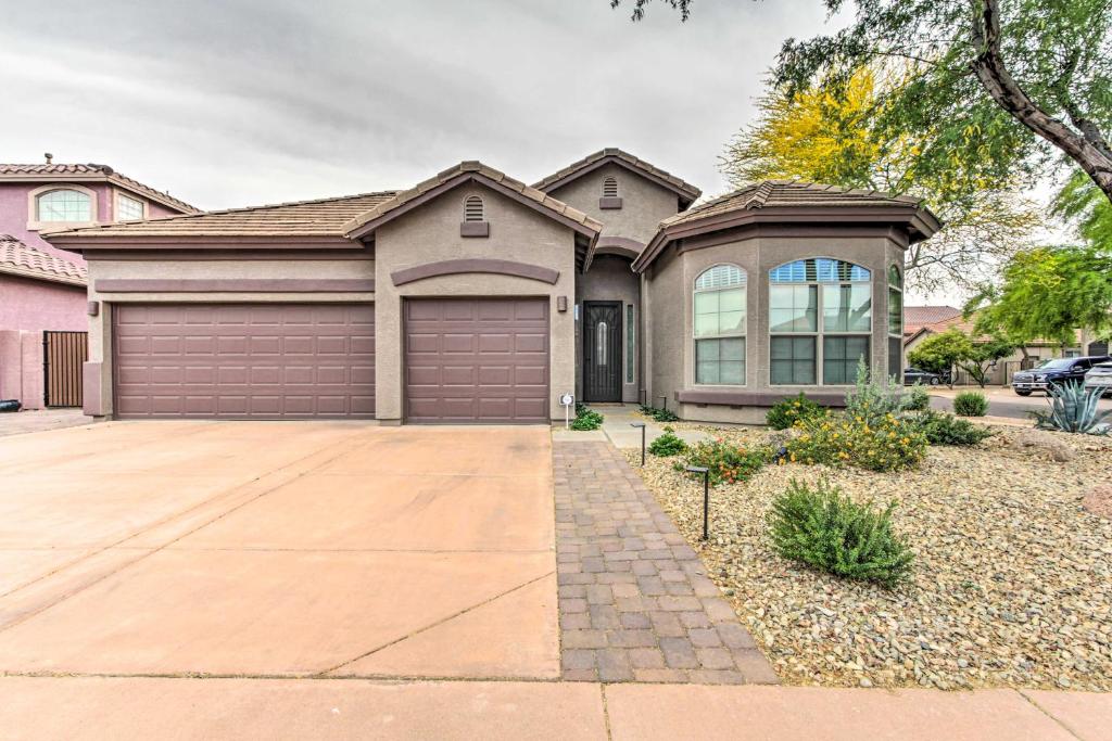 a large house with a garage at Bright Phoenix Home with Private Pool and Hot Tub in Anthem