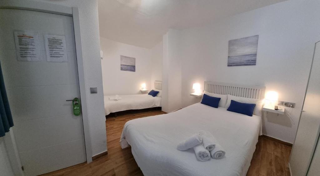 Postel nebo postele na pokoji v ubytování Hostal Nerjasol