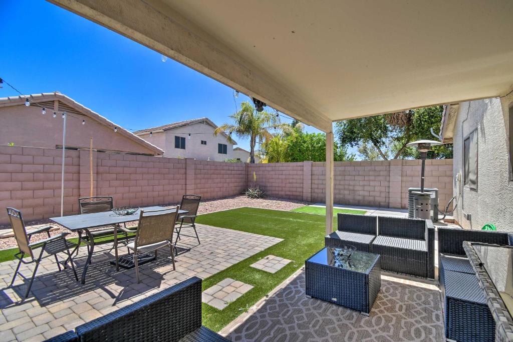 a patio with a table and chairs in a backyard at Avondale Retreat with Grill - 15 Mi to Phoenix! in Avondale