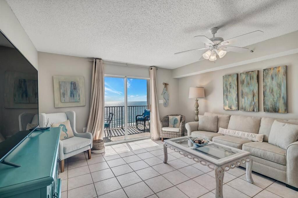 a living room with a couch and a pool table at Fourwinds 803 - Beachfront condo w/ Hall Bunks! - Elevator replacement 4/4-5/24 in Orange Beach