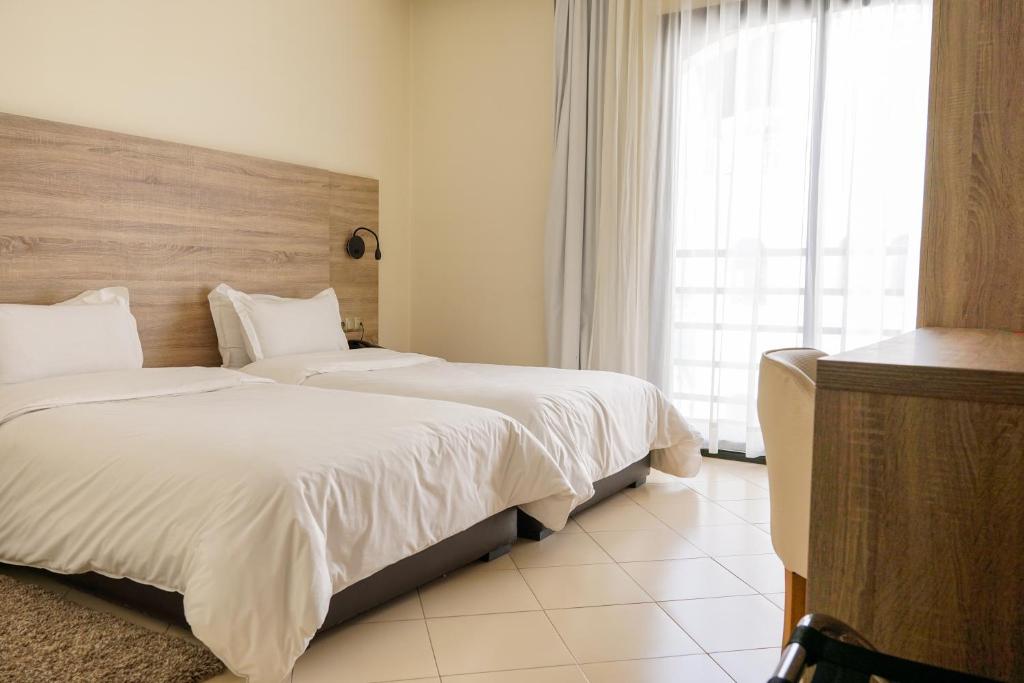 Postel nebo postele na pokoji v ubytování Hotel El Djenina