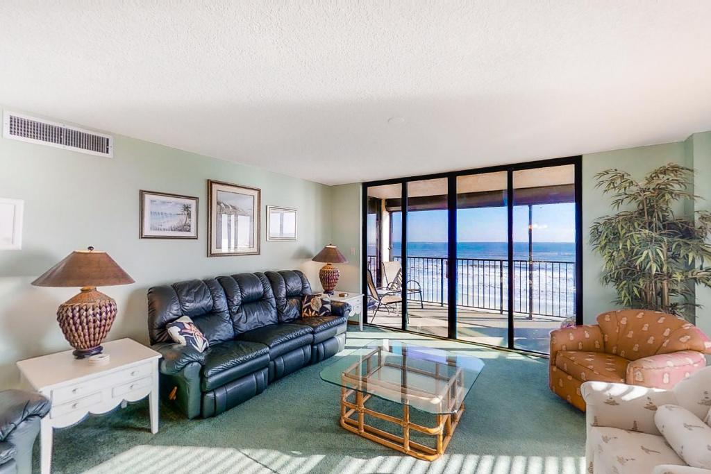 a living room with a couch and a view of the ocean at Sand Dollar II 408 in Saint Augustine