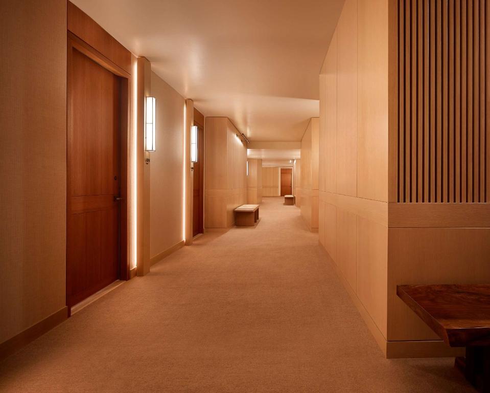 a long hallway with a bench in a building at Nobu Hotel Palo Alto in Palo Alto