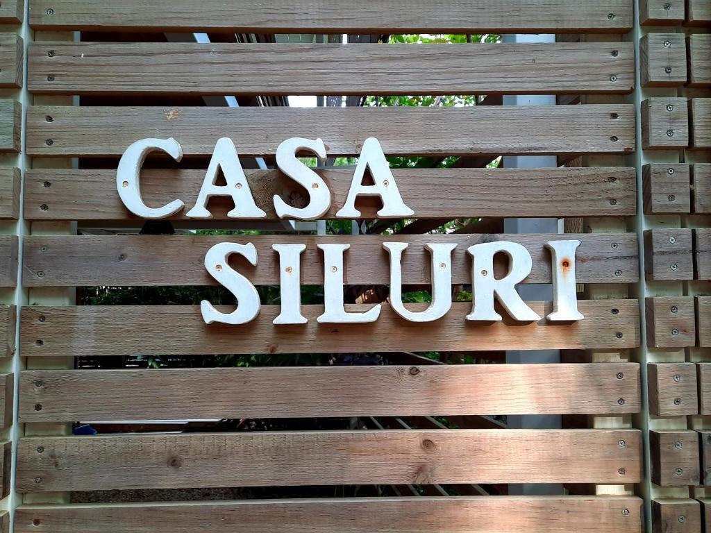 a sign on a fence that says casa slimp at Casa SILURI in Santa Teresa Beach