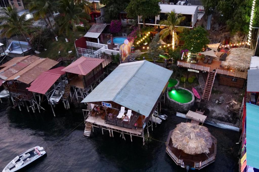 an aerial view of a resort on the water at Captain Morgan Hostel Lake Coatepeque in Santa Ana