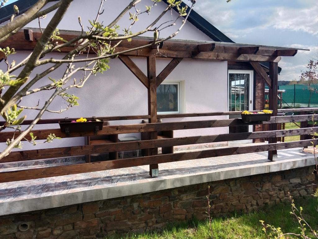 a wooden fence in front of a house at Welness, Holiday Cheb-Skalka in Cheb