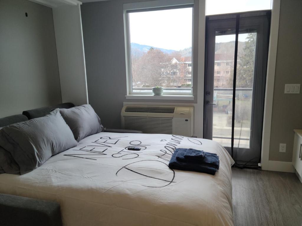 a bed with a drawing on it in a bedroom at Cozy Studio Suite, 15min walk to downtown in Kelowna