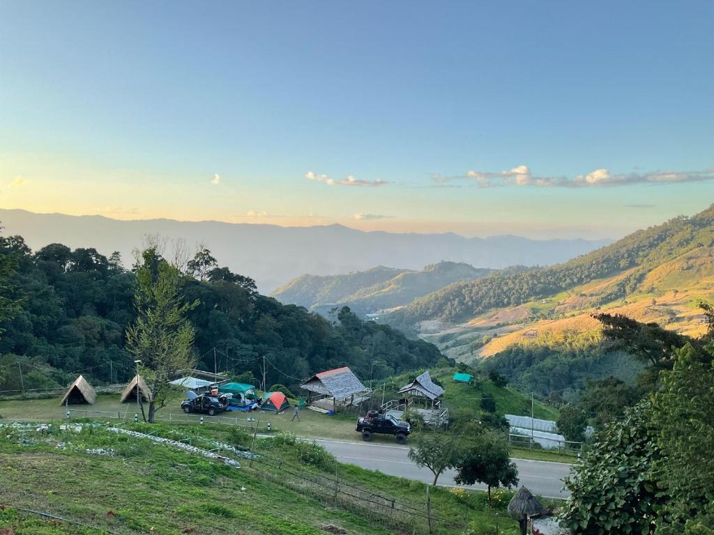 a village in the mountains with a view of a valley at Ban Chomdoi Resort PhaTang in Ban Pha Tang