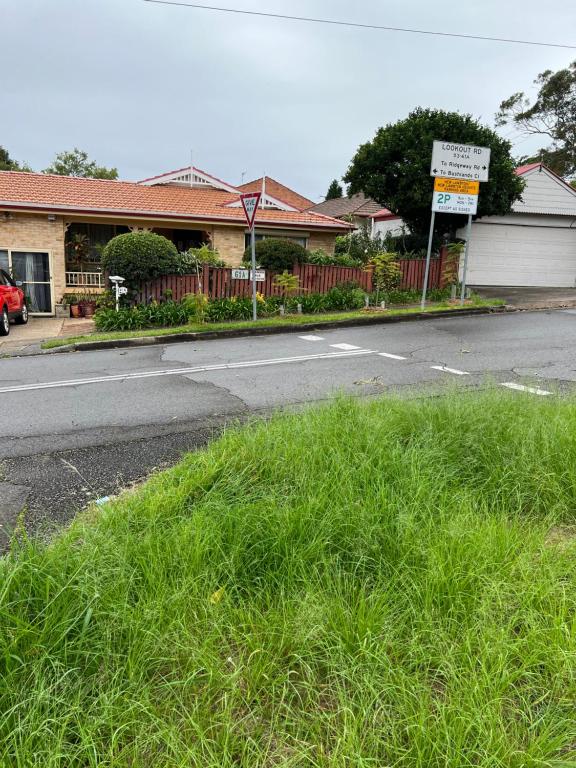 a street with a grassy median in front of a house at JOHN HUNTER B&B in Lambton