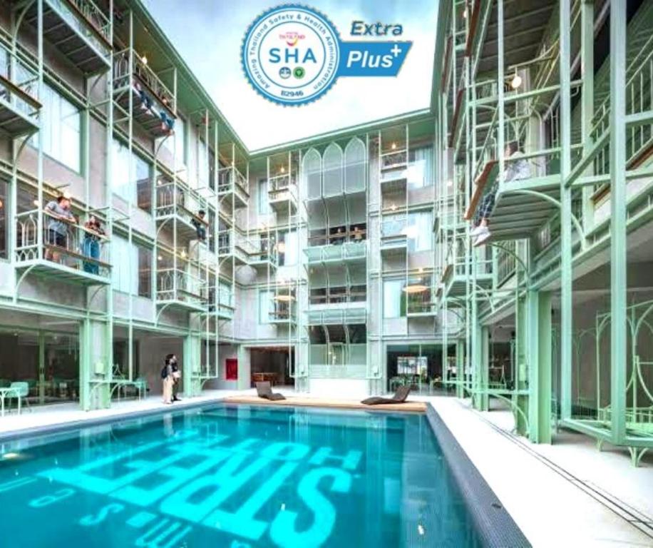 a large swimming pool in a building at Samsen Street Hotel in Bangkok