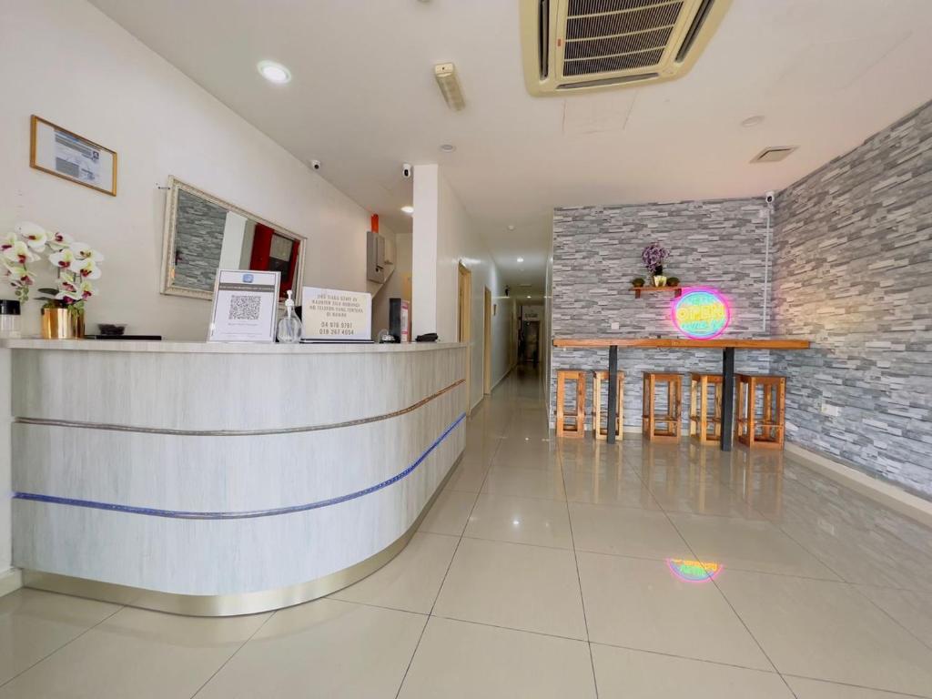 a restaurant lobby with a counter and a bar at Noor Hotel Kangar in Kangar