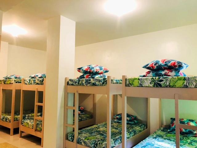 a room with three bunk beds in a room at Villa Leah Natural Hotspring Resort in Calamba