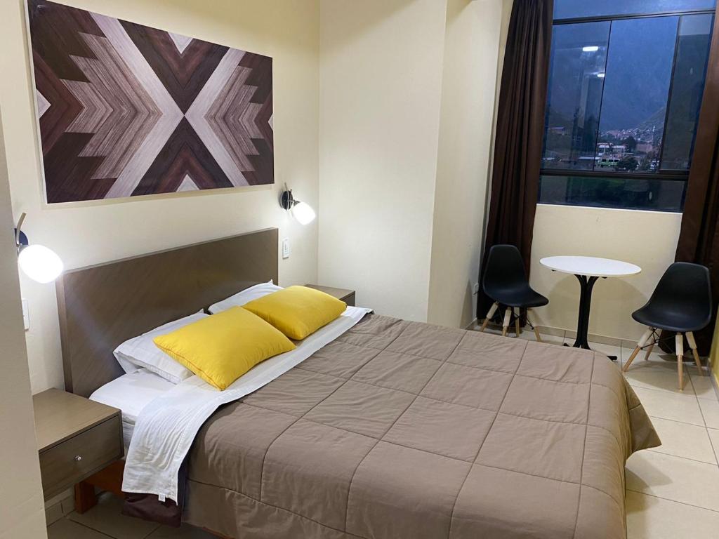 A bed or beds in a room at Hostal Tambo Alto