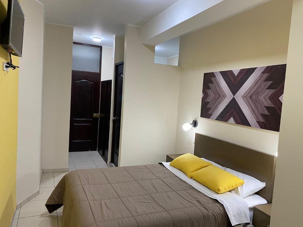A bed or beds in a room at Hostal Tambo Alto