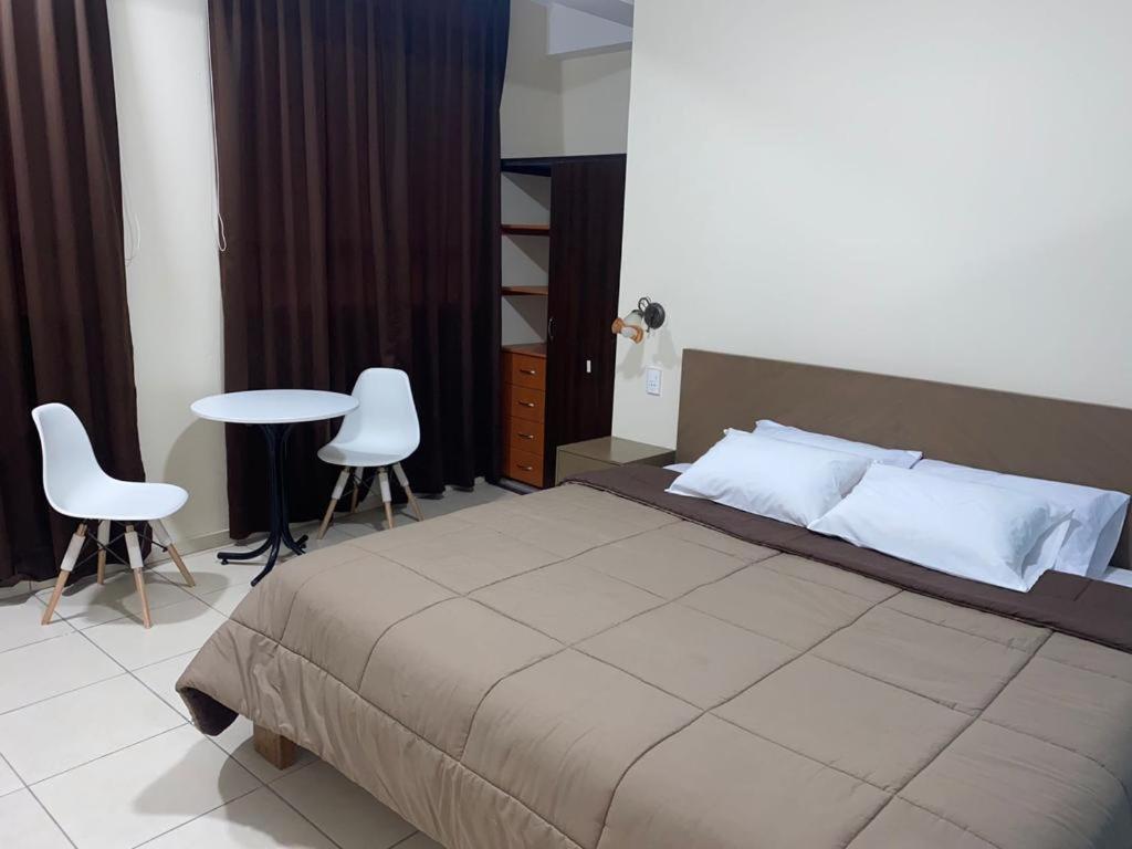 A bed or beds in a room at Hostal Tambo Alto