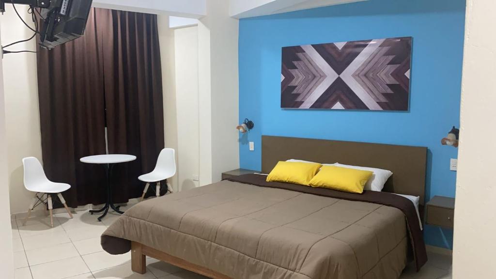 A bed or beds in a room at Hostal Tambo Alto