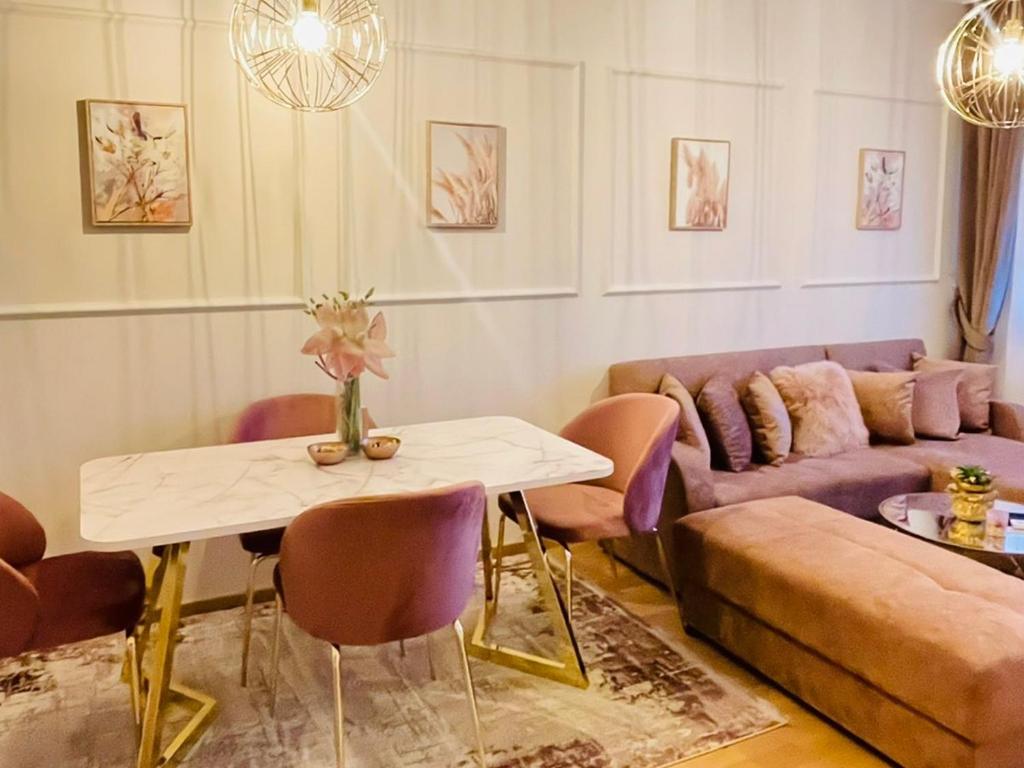 a living room with a couch and a table at Stan na dan "Apartman Purple" in Banja Luka