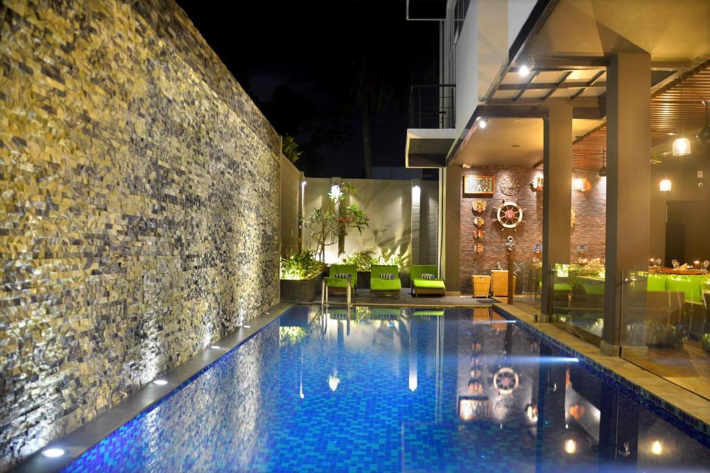 a swimming pool in the middle of a house at night at Belmont Boutique Hotel in Negombo