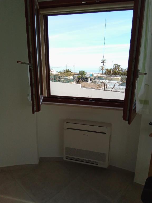 a window in a room with a air conditioner and a window at Villa Anna Maria in Polignano a Mare