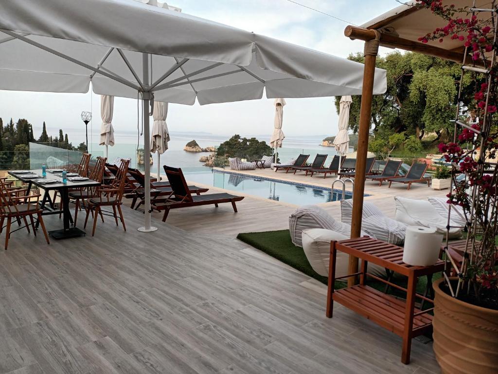 a patio with a table and chairs and a pool at Agnanti in Parga