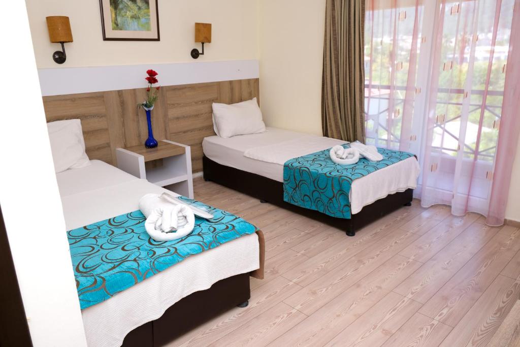 Postel nebo postele na pokoji v ubytování Beldibi Beach Hotel