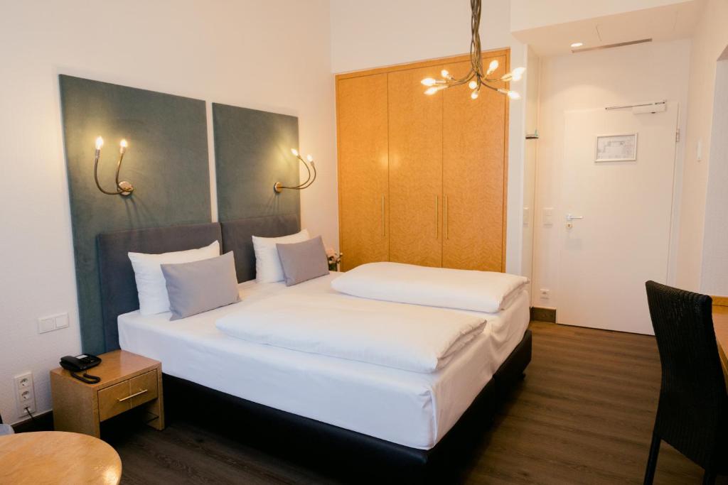 Postel nebo postele na pokoji v ubytování DOM Hotel LIMBURG