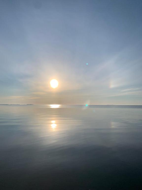 a large body of water with the sun in the sky at Beautiful view in Nida
