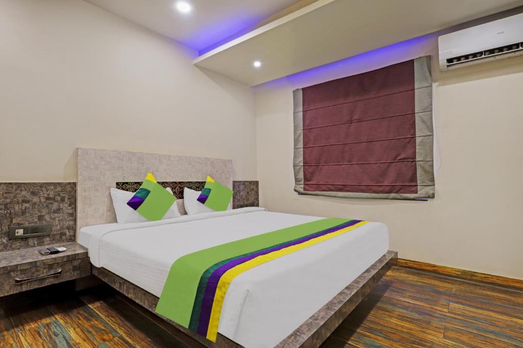 a bedroom with a large bed in a room at Itsy By Treebo - Ransu Residency in Guwahati