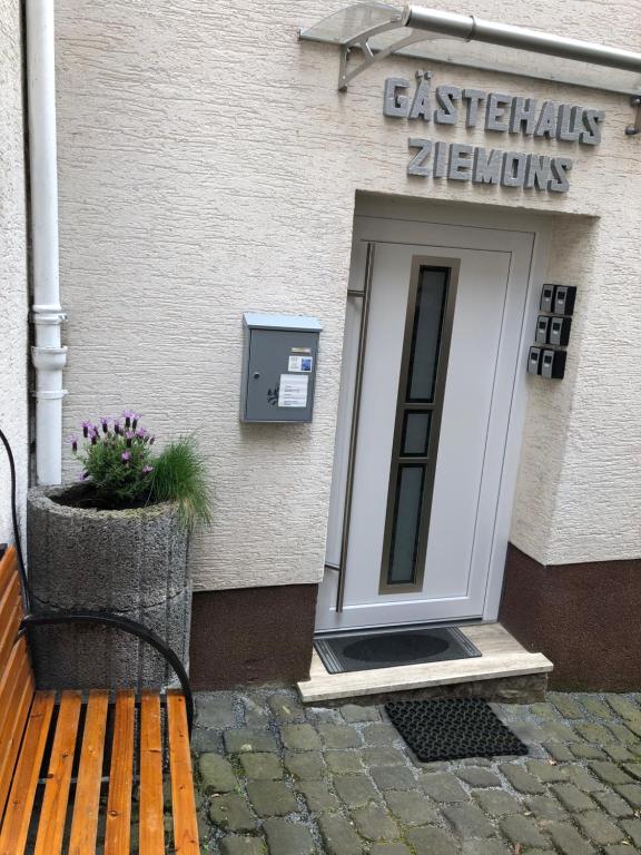 a wooden bench sitting in front of a building at Gästehaus Ziemons in Cochem