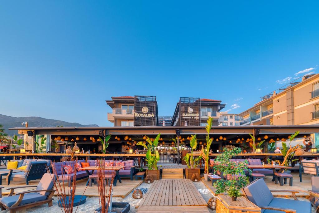 an outdoor patio with tables and chairs on a building at Royalisa Palmiye Beach Hotel Adult Only in Alanya