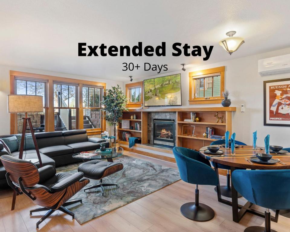 an extended stay in a living room with a fireplace at Sleek Condo - Near Park, Poudre River and Old Town in Fort Collins
