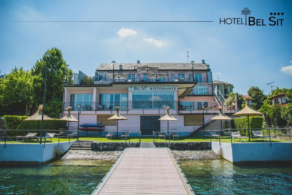 a building with a dock in front of the water at Hotel Bel Sit in Meina