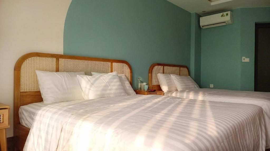 Postel nebo postele na pokoji v ubytování Lacovy Home Hội An