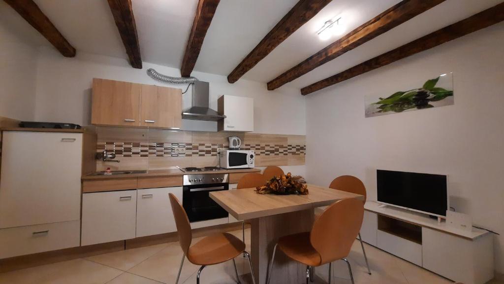 a kitchen with a table and chairs in a room at Holiday Home Benny in Crikvenica