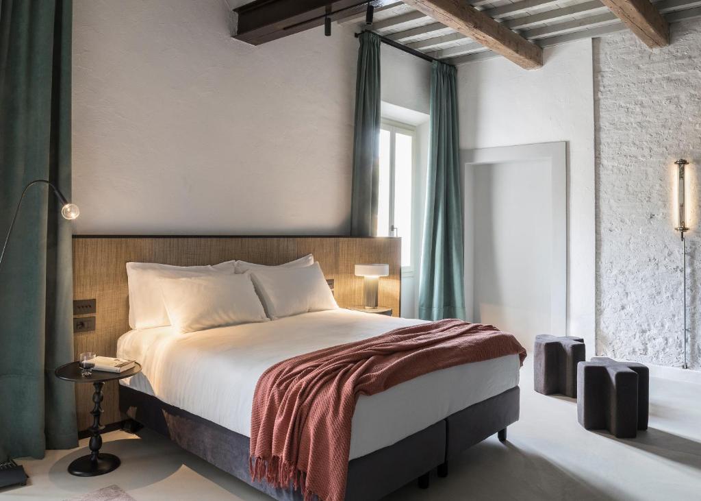 a bedroom with a large bed and a window at Antica Dimora Le Misure in Cervia
