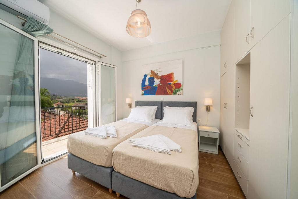 Postel nebo postele na pokoji v ubytování Ilias Apartments