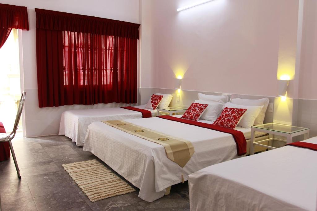 a hotel room with two beds and a red window at QUANG SAIGON Hotel- 40-7 Bùi Viện-Walking street in Ho Chi Minh City