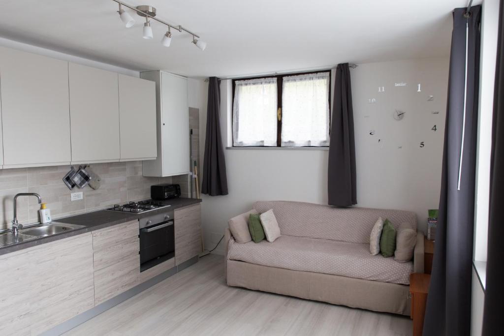 sala de estar con sofá y cocina en Appartamento Speranza, en Molina di Ledro