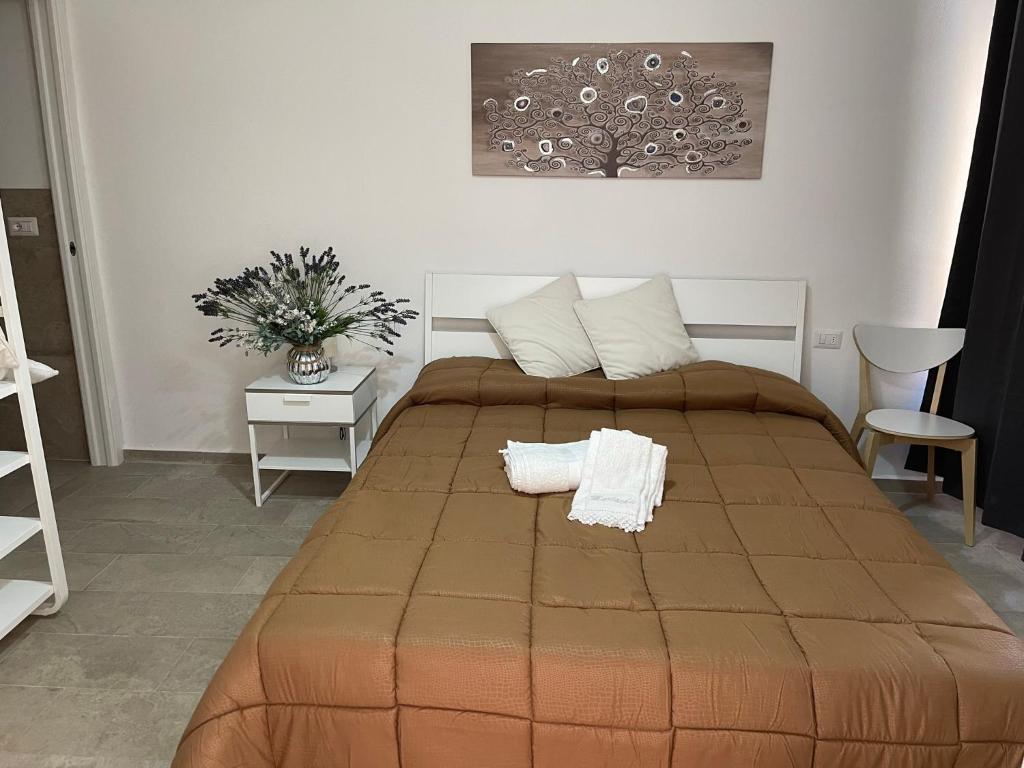 a bedroom with a large bed with two towels on it at Matty's in Olbia