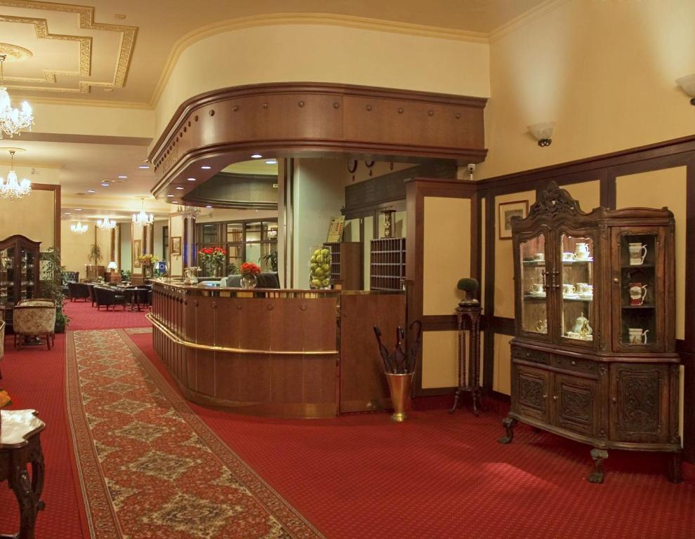 a lobby with a bar in a hotel at Interhotel Central in Karlovy Vary