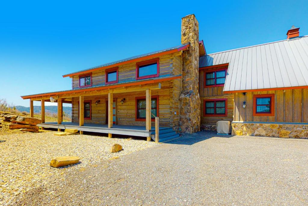 a large wooden house with a stone building at Rocky Mountain Way in Pagosa Springs