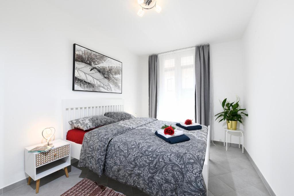 a white bedroom with a bed and a window at Aria Apartment - Free Parking in Bioggio