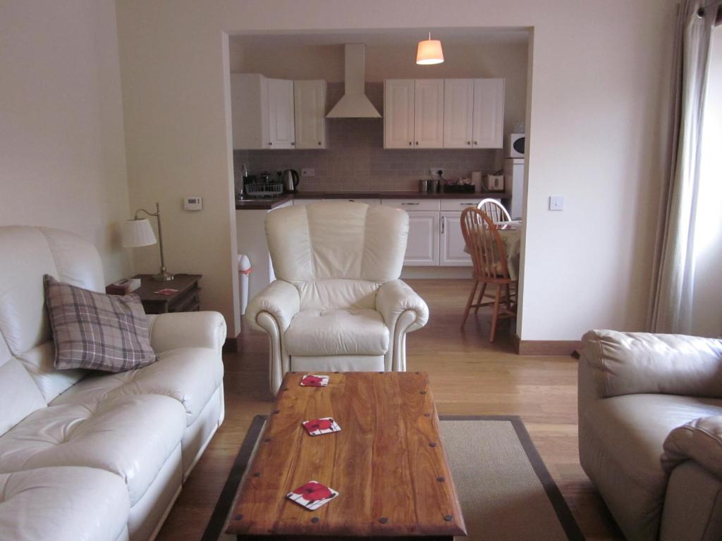 a living room with a couch and chairs and a table at Easter Bowhouse Farm Cottage in Linlithgow