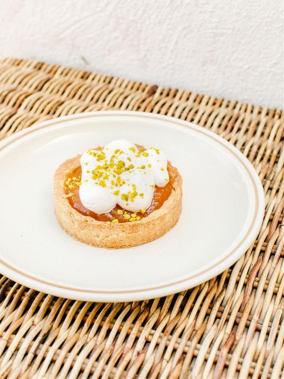 a piece of bread with whipped cream and sprinkles on a plate at Hôtel Restaurant Les Arnelles in Saintes-Maries-de-la-Mer