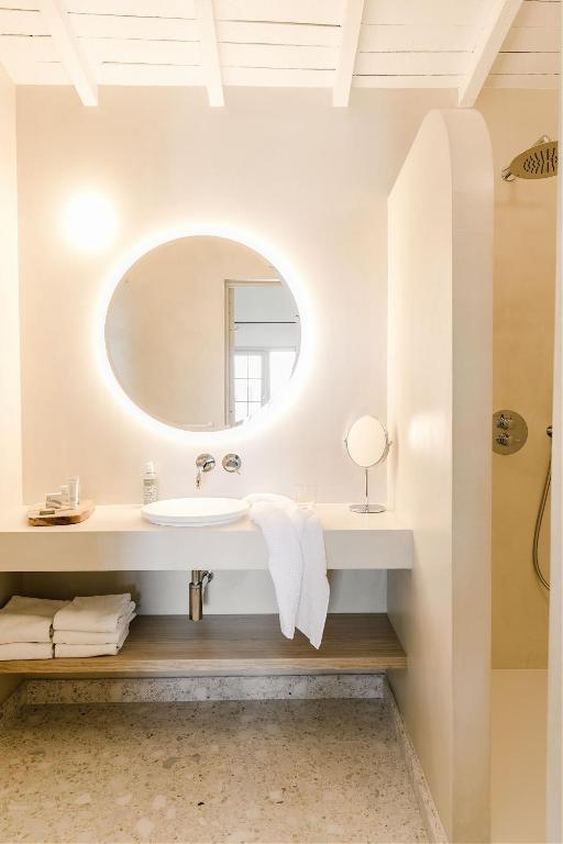 a bathroom with a sink and a mirror at Hôtel Restaurant Les Arnelles in Saintes-Maries-de-la-Mer