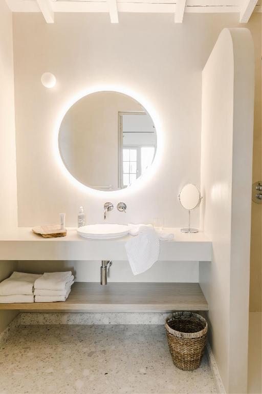a bathroom with a sink and a mirror at Hôtel Restaurant Les Arnelles in Saintes-Maries-de-la-Mer