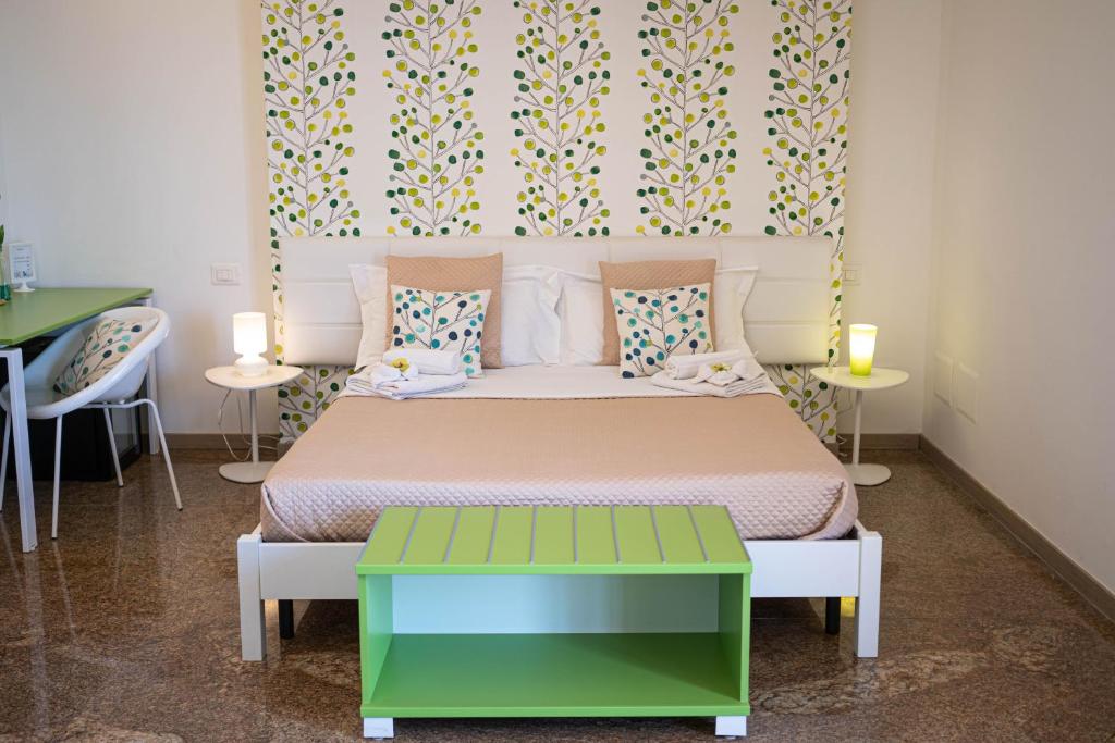 a bedroom with a bed with a colorful headboard at B&B Agramonte in Ispica